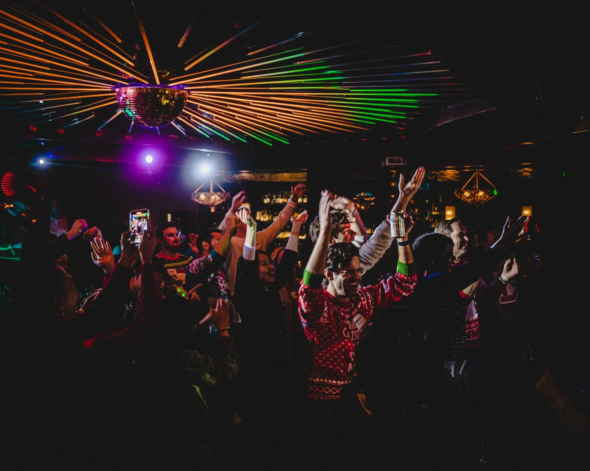 Audience singing along and dancing at a live band karaoke night
